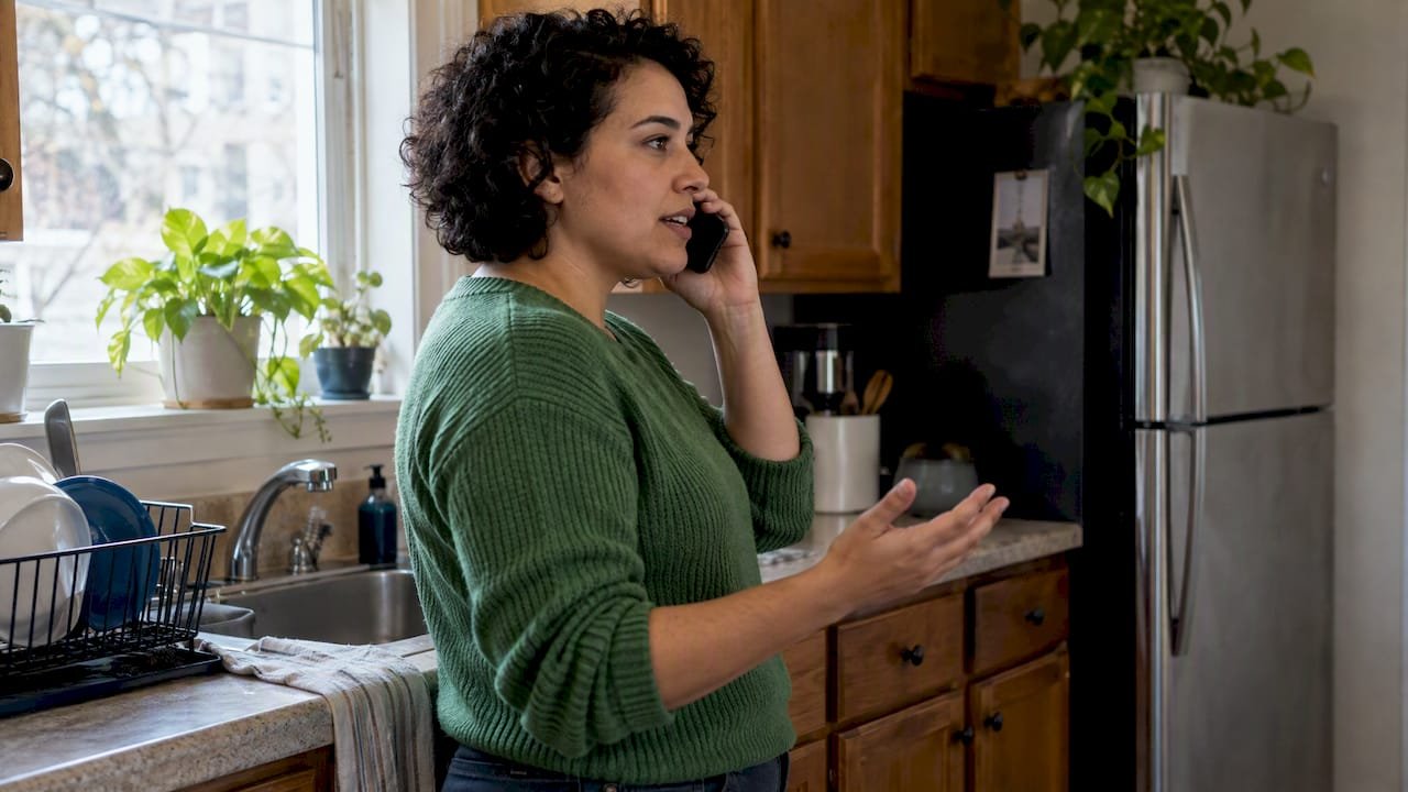 Household member negotiating a bill by phone