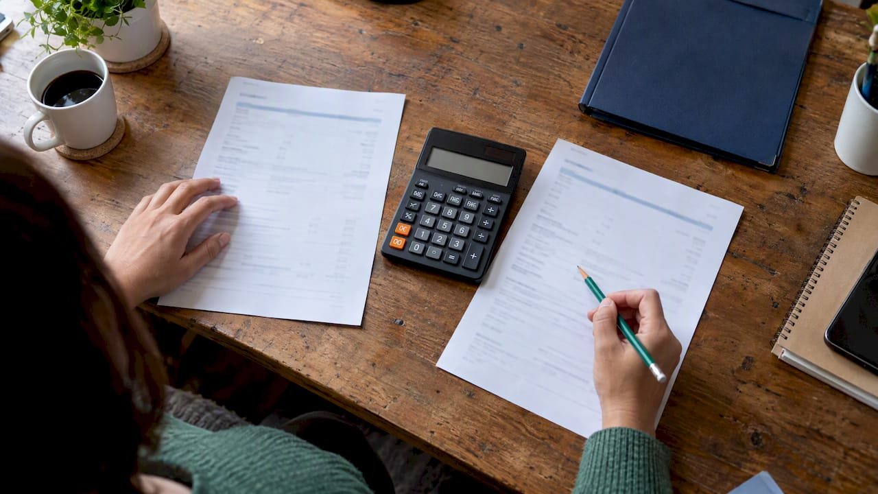 Mortgage estimates and calculator on desk