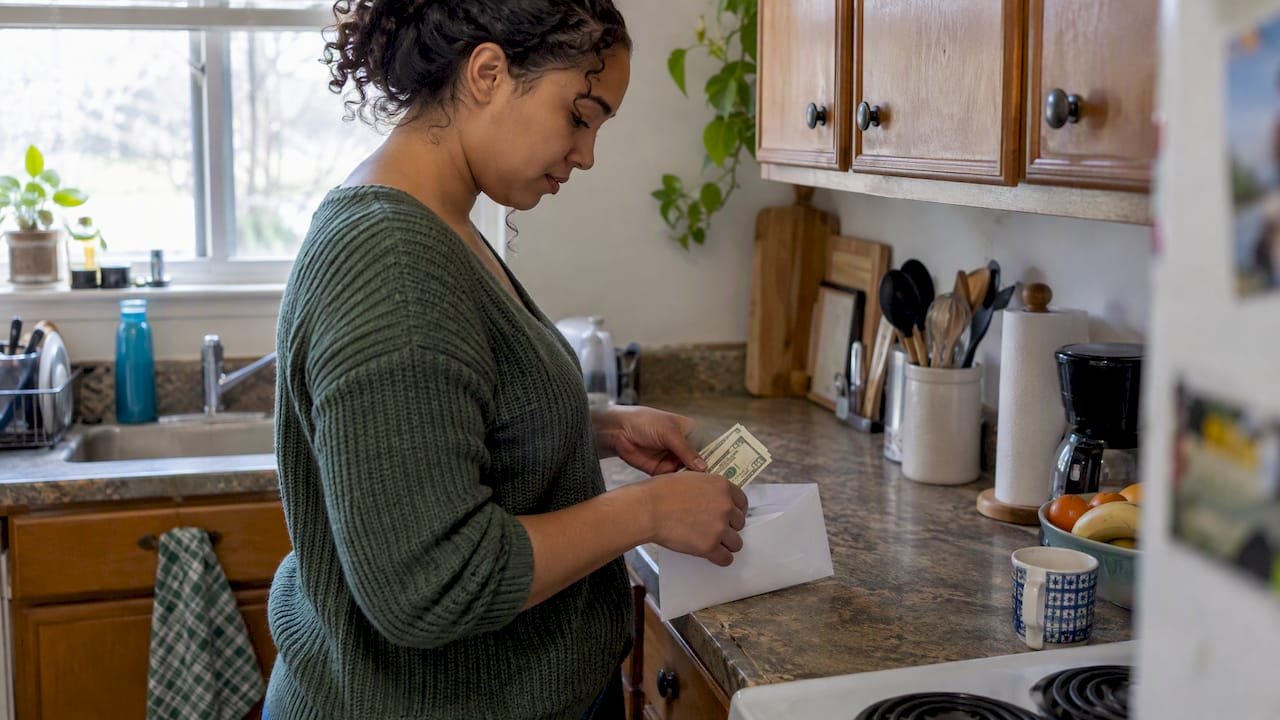 Woman setting aside cash for savings